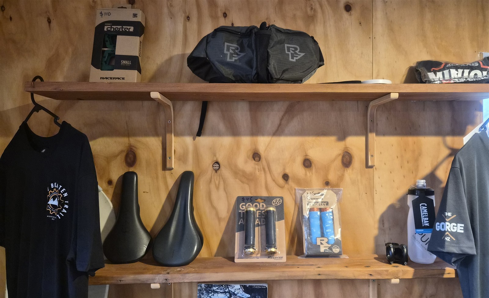 Bike saddles, grips, pedals, bag and drink bottle on display